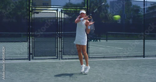 Girl playing tennis on court