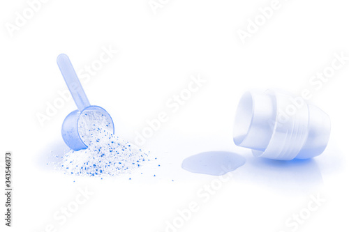Washer background. Liquid or powder detergents in cup for laundry isolated on white. Clean soap texture in scoop for wash machine. Dry cleaning, Chores of housewife concept. Regular washing.