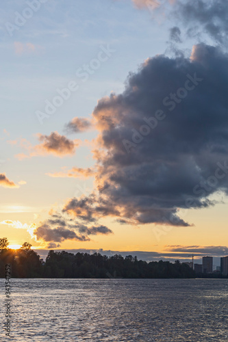 evening sky with dark and golden sunset clouds as a natural background