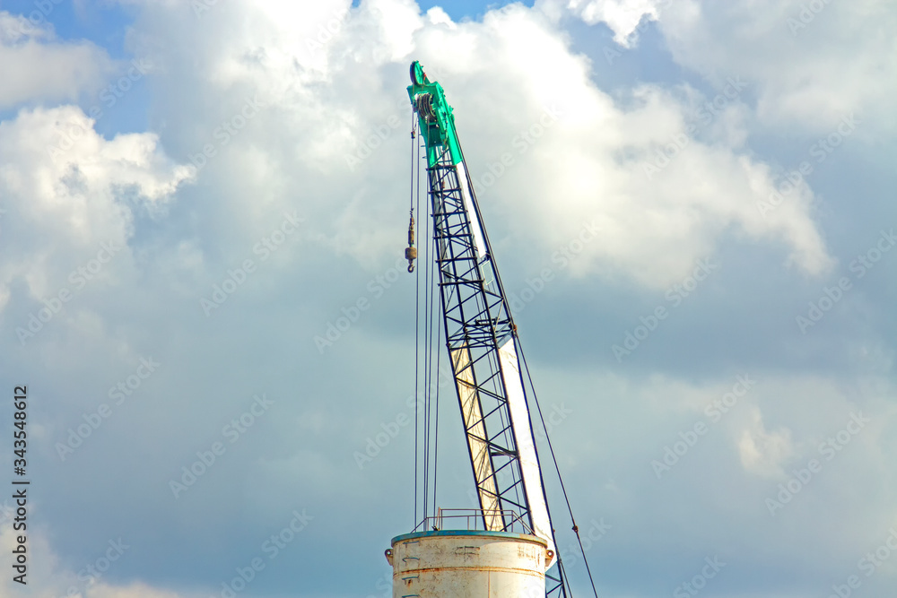 Crane lift green working In the blue sky backgound Crane lift green working In the blue sky backgound