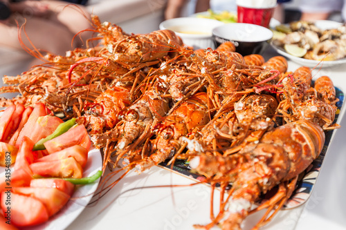 Photography Cooked spiny lobsters langostos laying on a dish