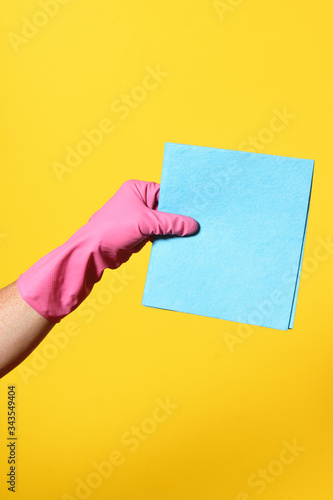 Fotografie hand with baize on yellow background