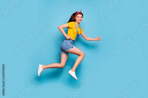 Fototapeta Naklejka Na Ścianę i Meble -  Full length body size view of her she nice attractive lovely cheerful cheery energetic girl jumping running fast isolated over bright vivid shine vibrant blue color background