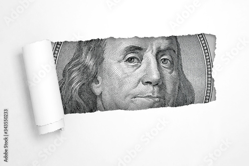Benjamin Franklin on a Hundred Dollar Bill in the Hole of Torn White Paper. 3d Rendering