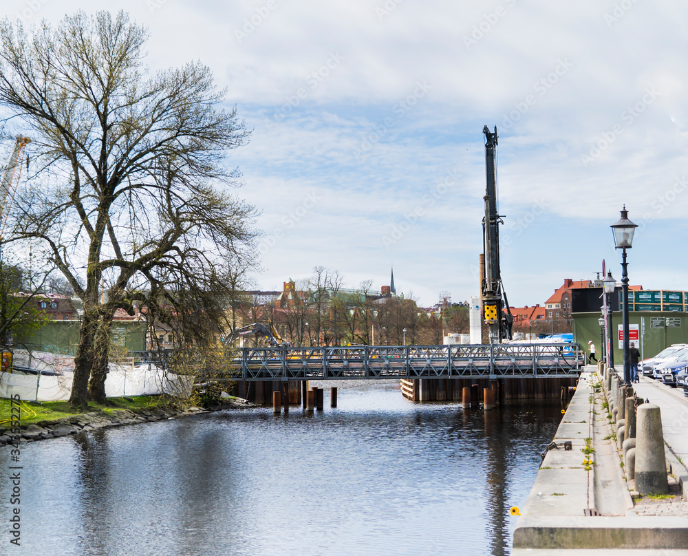 Bridge over the canal in Rosenlund, Gothenburg. In the background, västlänken(the West Link) and Haga station are being built.