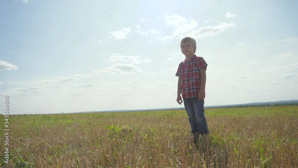 sad little boy stands lifestyle with his back on nature covered his face with his hands is not a happy childhood concept sad little boy stands lifestyle with his back on nature covered his face with his hands is not a happy childhood concept
