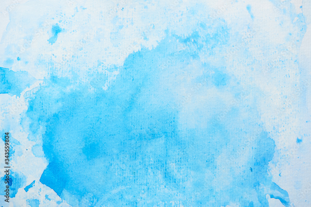 Hand painted blue watercolor abstract stain on white paper. Paint splash background