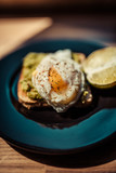 Poached egg with avocado cream on toast