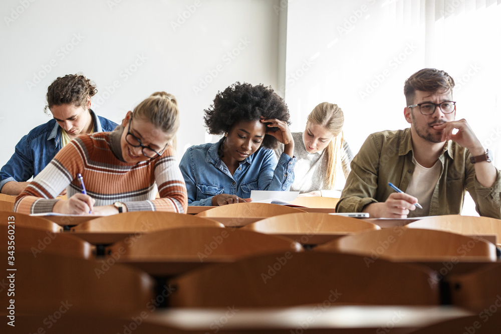 Group of university students taking a test in a classroom.Educational concept.	
 - obrazy, fototapety, plakaty 