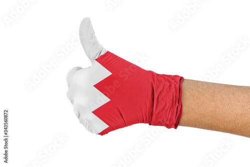 Bahrain flag on a hand glove showing thumbs up sign photo