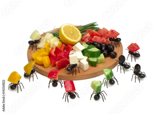 Funny ants collect ingredients for greek salad on white background photo