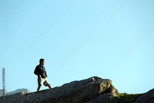 man standing on top of mountain