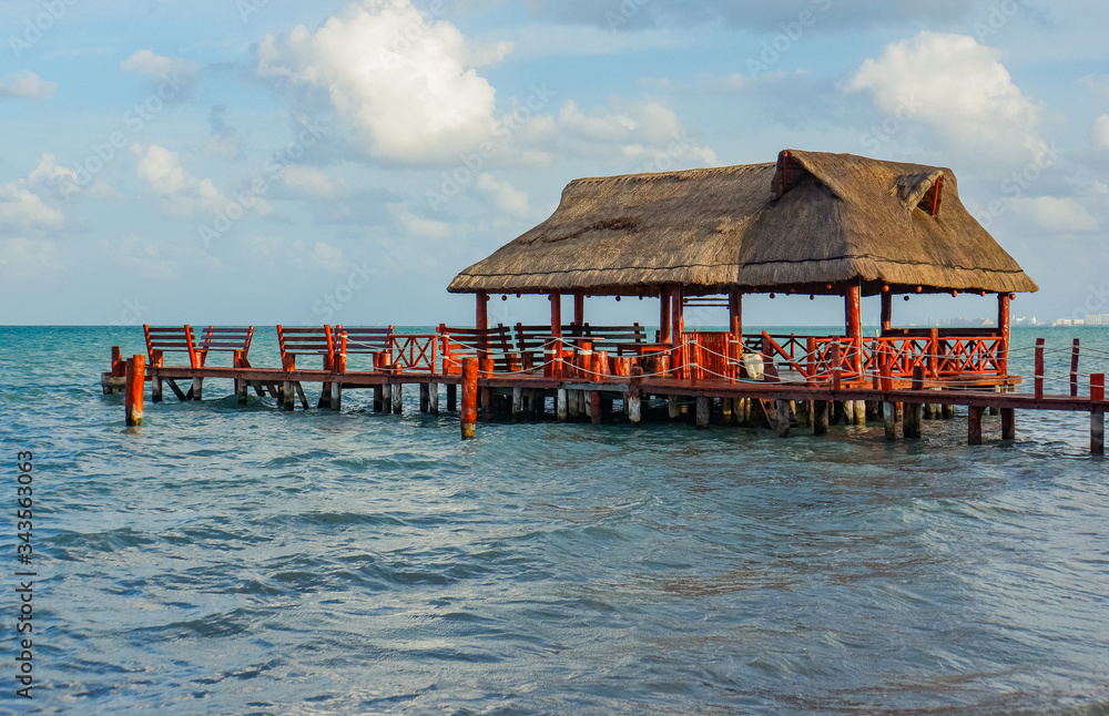 the beach with two palapas, traditional Mexican shelter with thatched roof of palm leaves 
