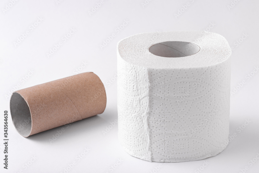 Obraz premium An empty roll of toilet paper and an entire roll isolated on a white background