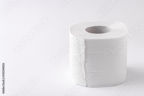 A roll of toilet paper on a white background. Copy space. Space for text.