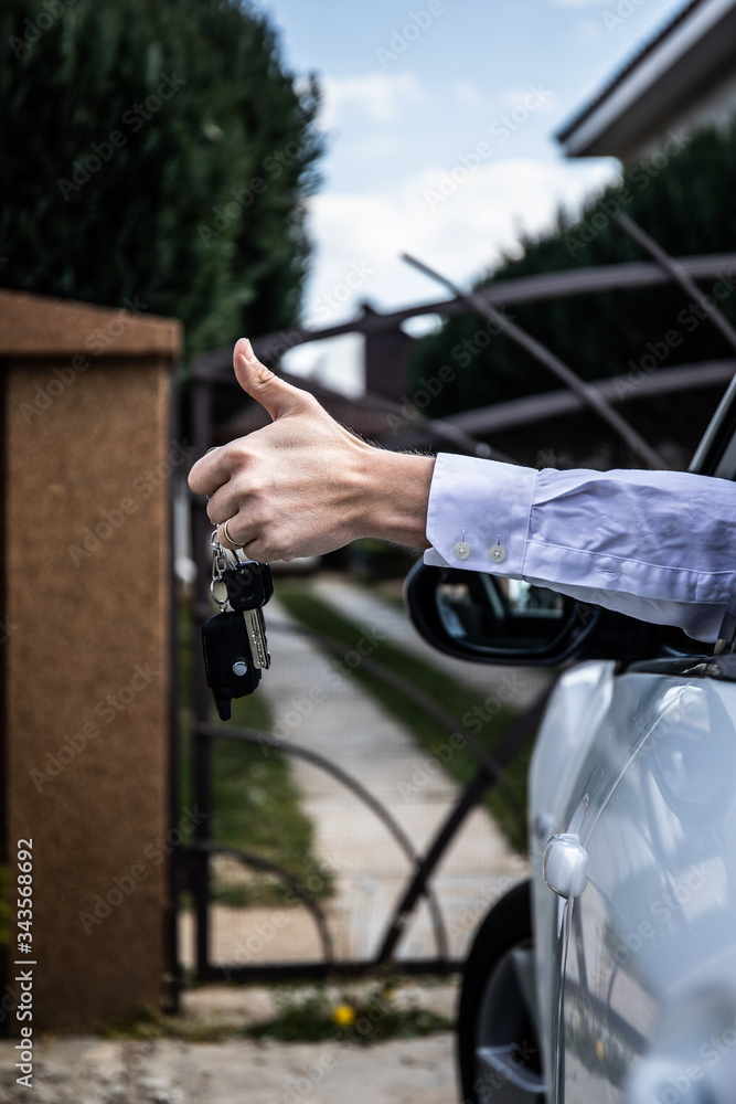 Car key, businessman handing over gives the car key to the other man on car background. Car key, businessman handing over gives the car key to the other man on car background.