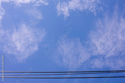 The atmosphere in the sky has high-voltage electricity lines passing through.