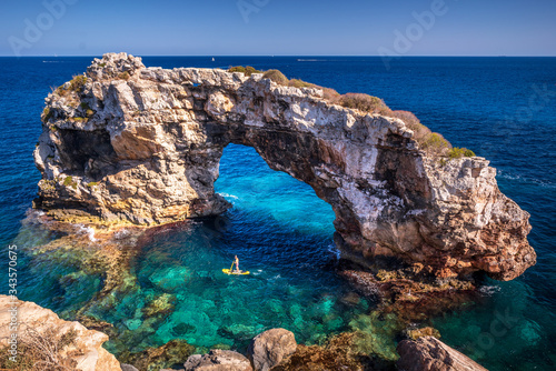Blue water and sunny day at the Beautiful nature wonder in Palma de Mallorca. Es Pontas natural rock formations in Palma de Mallorca, Balearic Islands