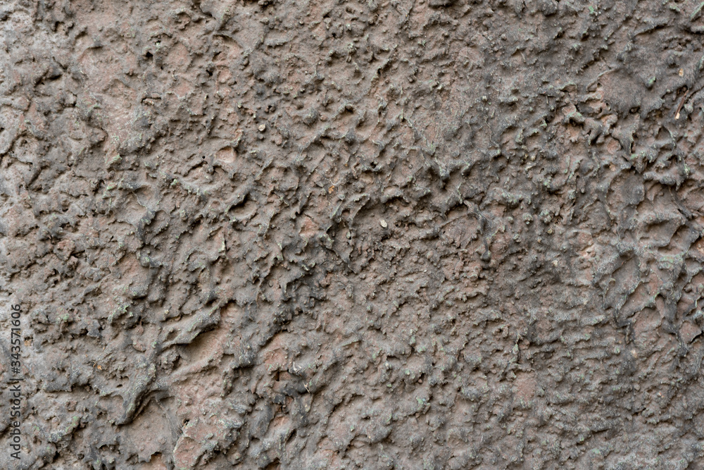 Close-up - gray-brown stone wall in the old facade of the house Close-up - gray-brown stone wall in the old facade of the house
