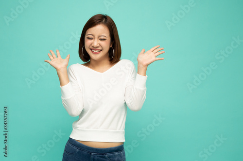 Portrait of excited screaming young asian woman wow and surprised