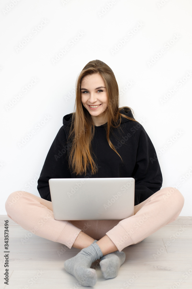 freelancer girl woman in sweater sitting on the floor with laptop computer, concept online education, work from home freelancer girl woman in sweater sitting on the floor with laptop computer, concept online education, work from home