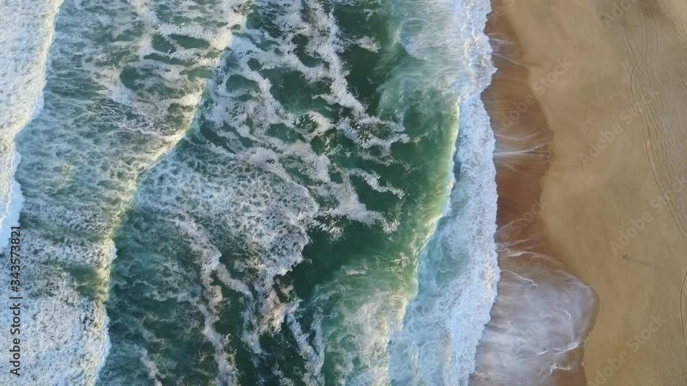 Aerial drone shot of a amazing beach with wave lines crashing on the shore Aerial drone shot of a amazing beach with wave lines crashing on the shore