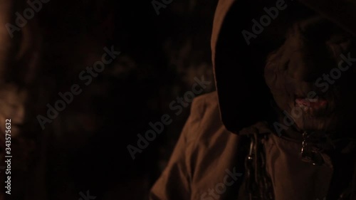 Silhouette of man maniac or killer or horror murderer with chainsaw in hand in dark creepy and spooky room. Criminal robber or rapist concept in thriller atmosphere with  victim girl