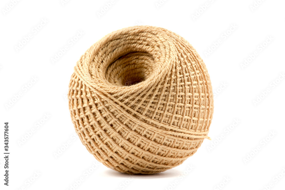 Big ball of beige threads on a white background Big ball of beige threads on a white background
