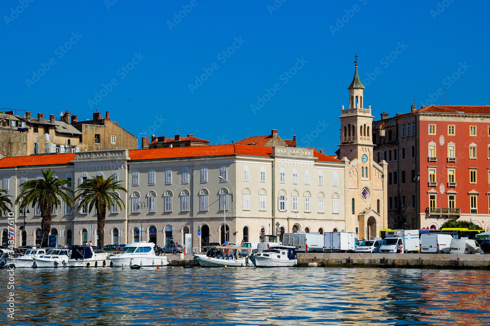 Church in Split's marina in Croatia - Reflection of old buildings in the waters of the Adriatic Sea in the urban harbor of this European city