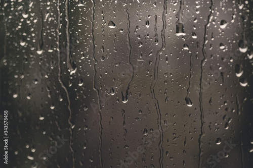 Rain drops on the window. Spring thunderstorm in April, May. Summer thunder. Summertime sadness, melancholy blues. Macro rain drops. Bokeh effect. Calmess and relaxation. Cloudy weather. Autumn day.