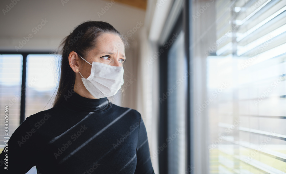 Woman with face masks indoors at home, Corona virus and quarantine concept.
