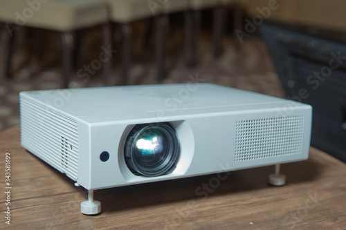 LCD video projector at business conference or lecture in office with copy space. projector on ceiling indoors . LCD video projector at business conference or lecture in office with copy space .