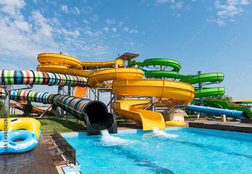 Water park with colorful slides and pools - obrazy, fototapety, plakaty 