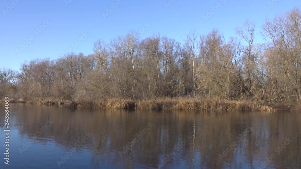 River and deciduous forest, landscape in winter season. River and deciduous forest, landscape in winter season.