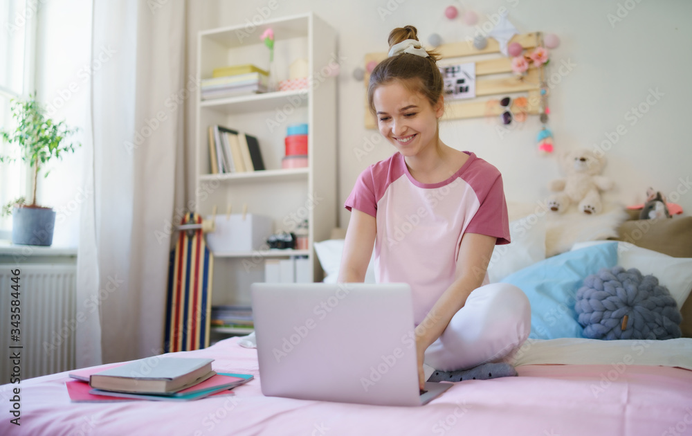 Young girl with tablet laptop on bed, relaxing during quarantine. Young girl with tablet laptop on bed, relaxing during quarantine.