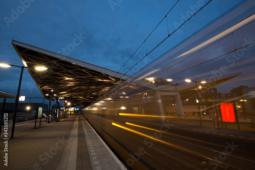 Train driving away from the train station at night
