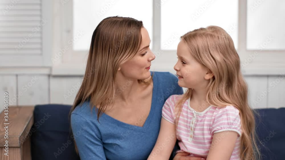 Mother talking with cute daughter playing touching nose. Medium close up shot on 4k RED camera Mother talking with cute daughter playing touching nose. Medium close up shot on 4k RED camera
