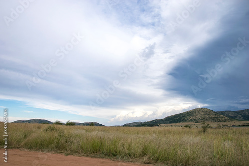 Cloudy skies over lush landscape, Pilanesberg National Park, South Africa