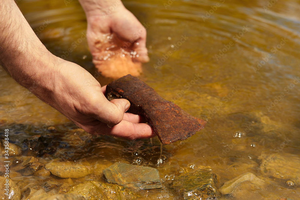 Man found rusty iron metal axe in river water by magnet Man found rusty iron metal axe in river water by magnet