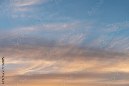 white flat and long clouds at sunset