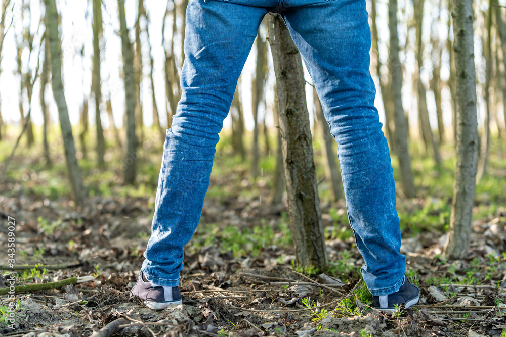 man peeing on a tree in the woods Stock Photo Adobe Stock