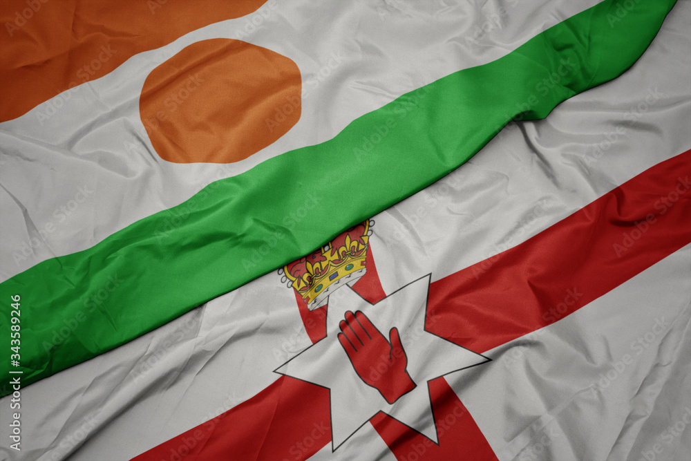 waving colorful flag of northern ireland and national flag of niger.