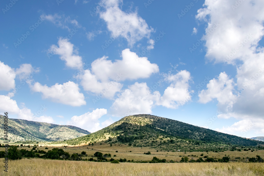 Cloudy skies over lush landscape, Pilanesberg National Park, South Africa
