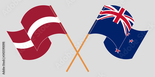Crossed and waving flags of New Zealand and Latvia