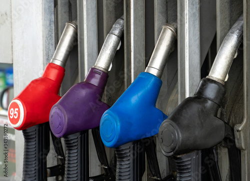 Colorful Petrol pump filling nozzles, Gas station in a service in daytime
