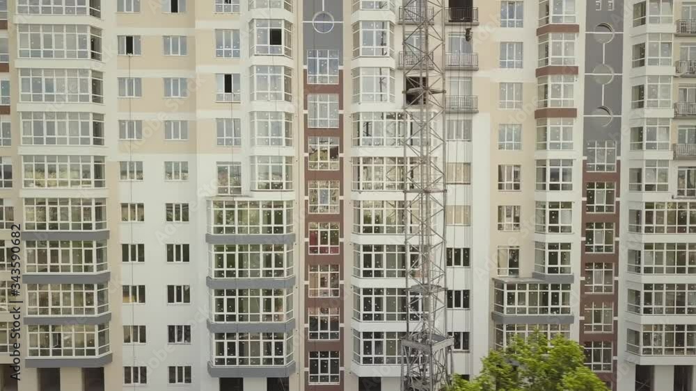 Aerial view of tall residential building under construction in a city. Aerial view of tall residential building under construction in a city.