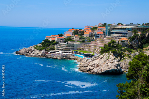 Fototapeta Naklejka Na Ścianę i Meble -  Hotel Rixos Dubrovnik on the coast of the Adriatic Sea in Croatia - Stepped building and swimming pool north of the walled city