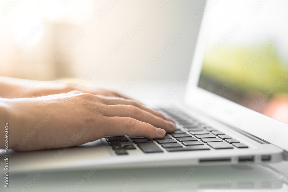 Hands writing on a Keyboard of a Laptop or Notebook in Home Office Hands writing on a Keyboard of a Laptop or Notebook in Home Office