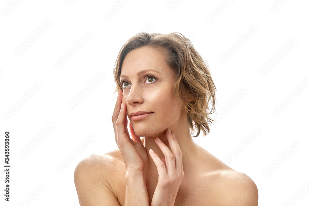 Beautiful young woman with a short haircut. Clean skin. Naked to the shoulders posing. isolated white background. Beautiful young woman with a short haircut. Clean skin. Naked to the shoulders posing. isolated white background.
