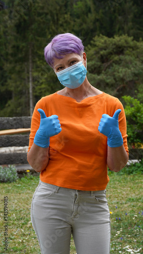 Happy woman in medical face mask with ok gesture. Woman in safety mask and medical gloves. Virus protection, health and hygiene concept
